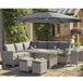 A 3.3m free arm parasol with LED lights and a Bluetooth speaker, displayed over an outdoor furniture set, set in a garden environment.